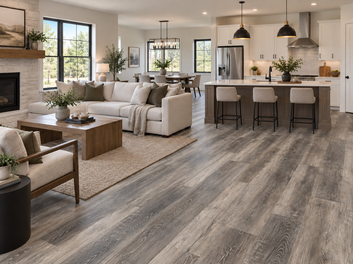 Living room and kitchen with gray luxury vinyl plank flooring.